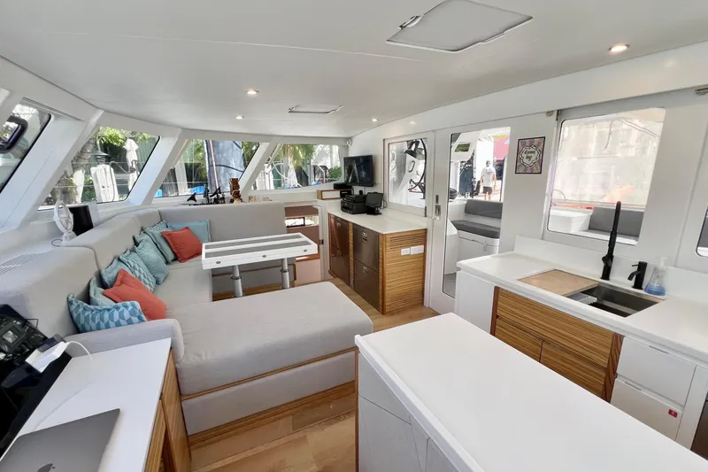 Slide: The Image of Interior of 2021 Balance 482 catamaran with modern helm, seating, and surfboards. - 40