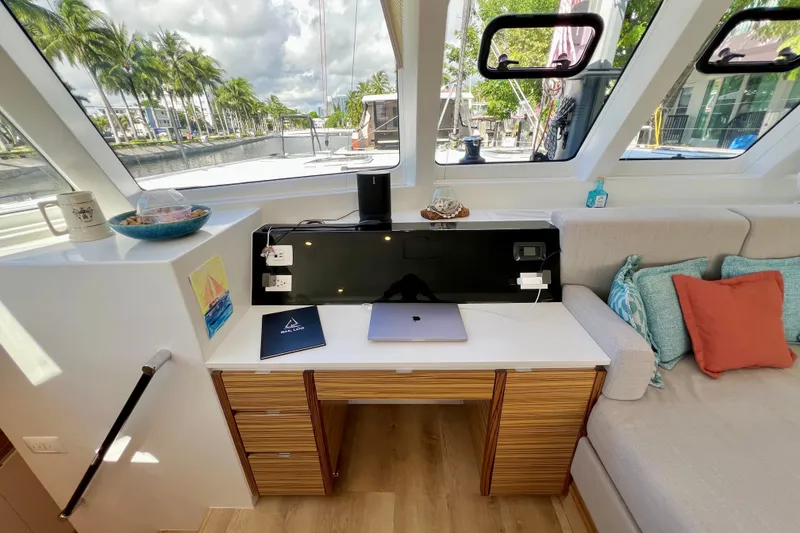 Slide: The Image of Modern yacht interior with cozy seating, colorful cushions, and large windows, Balance 482, 2021 model. - 48