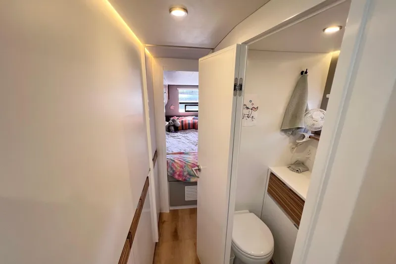 Slide: The Image of Modern interior of Balance 482 yacht, featuring wooden steps, wall art, and a small window. - 75
