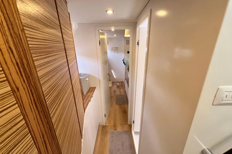 Slide: The Image of Narrow hallway leading to a cozy bedroom in a 2021 Balance 482 model. - 81