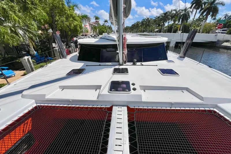 Slide: The Image of Red Balance 482 catamaran sailing on open sea under clear blue sky, 2021 model. - 9