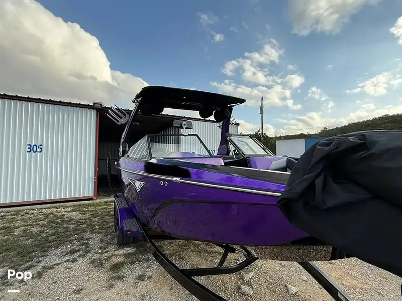 Slide: The Image of 2022 Tigé Z3 boat in vibrant purple, parked outdoors near storage unit 305. - 8