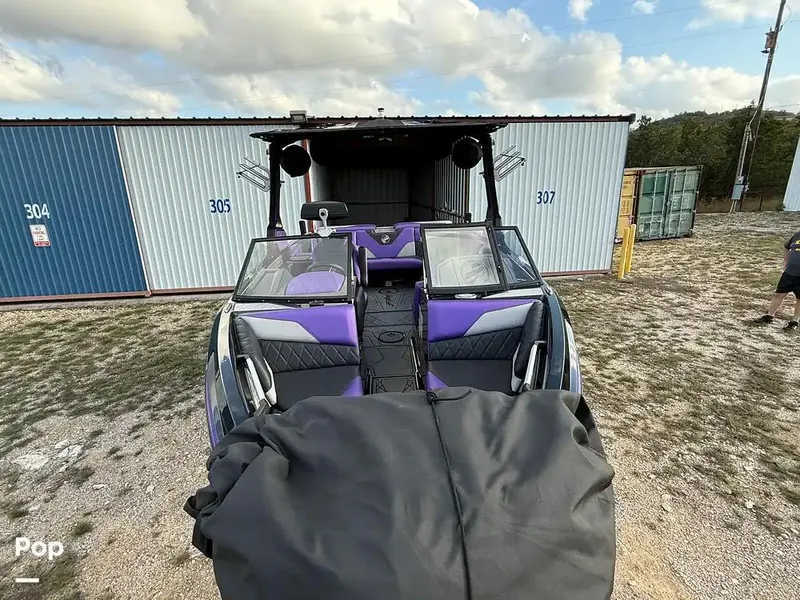 Slide: The Image of 2022 Tigé Z3 boat with purple interior, parked outside storage units. - 9