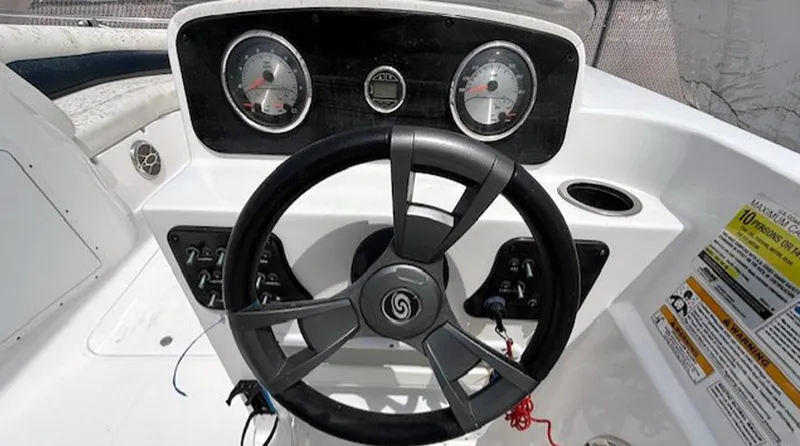 Slide: The Image of 2015 Hurricane SunDeck Sport 188 OB boat dashboard with steering wheel and gauges. - 11