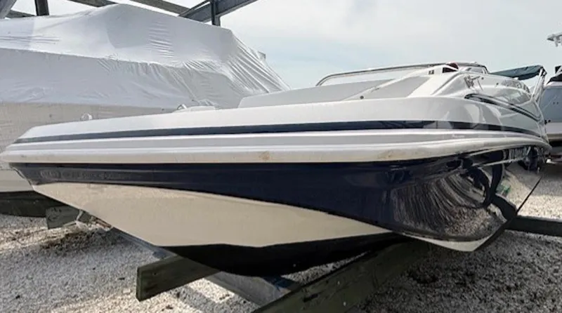 Slide: The Image of 2015 Hurricane SunDeck Sport 188 OB boat on a trailer, side view. - 2
