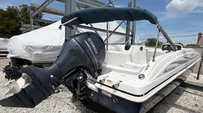Slide: The Image of 2015 Hurricane SunDeck Sport 188 OB boat with Yamaha outboard motor, parked on gravel. - 4