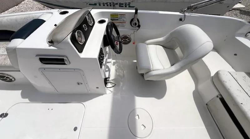 Slide: The Image of 2015 Hurricane SunDeck Sport 188 OB boat interior with steering console and white seating. - 9