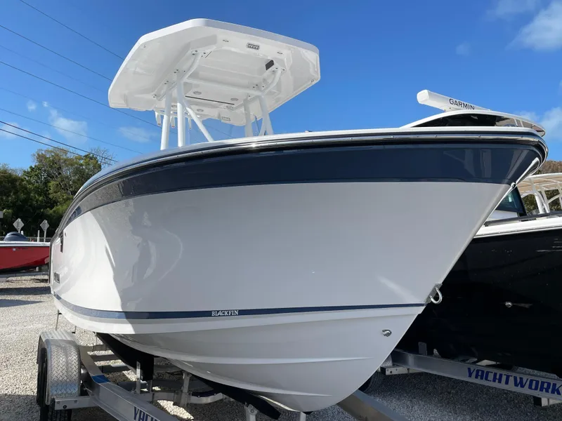 The Image of 2025 Blackfin 222CC boat on trailer, sleek design, white and blue accents. - 0