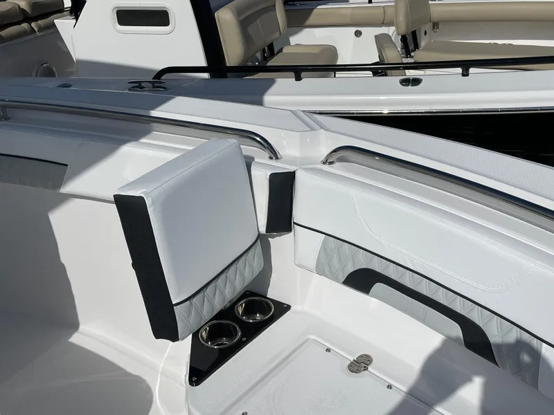 Slide: The Image of 2025 Blackfin 222CC boat interior with white seating and cup holders. - 10