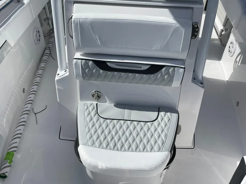 Slide: The Image of 2025 Blackfin 222CC boat interior with diamond-stitched seating and modern design. - 11