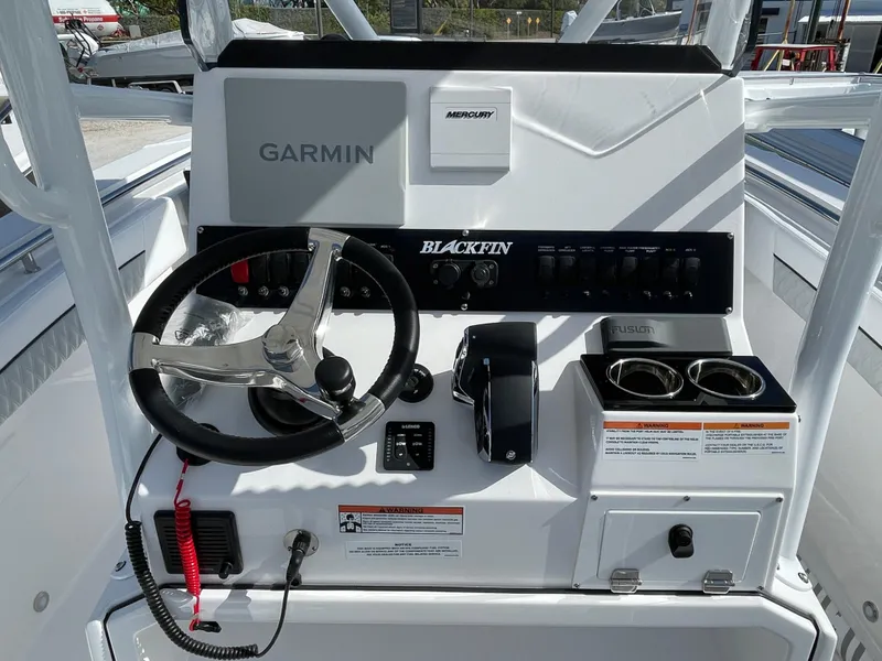 Slide: The Image of 2025 Blackfin 222CC boat console with Garmin navigation and Mercury controls. - 13