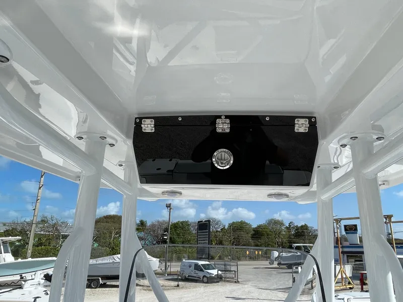 Slide: The Image of 2025 Blackfin 222CC boat interior, showcasing sleek design and modern features under a clear blue sky. - 14