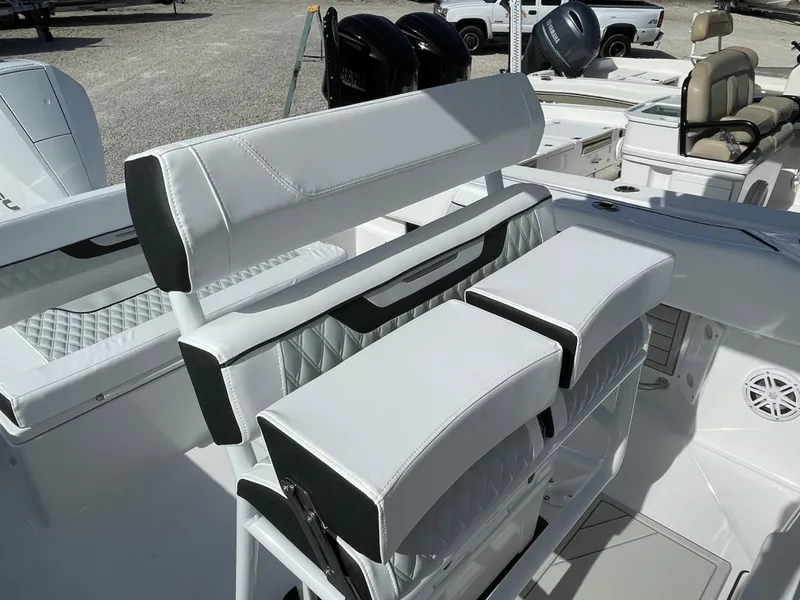 Slide: The Image of 2025 Blackfin 222CC boat interior with white cushioned seating and modern design. - 15