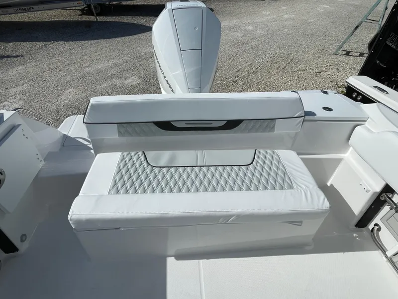 Slide: The Image of 2025 Blackfin 222CC boat with white cushioned seating and diamond pattern design. - 19