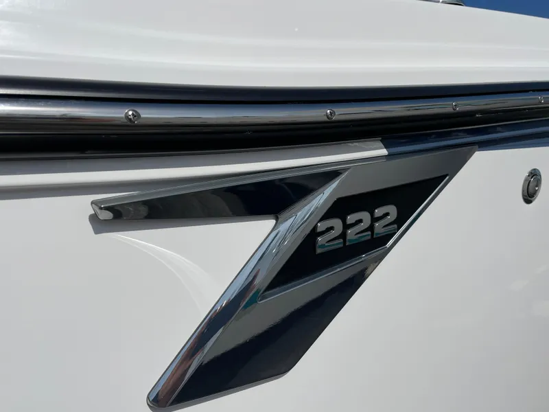 Slide: The Image of 2025 Blackfin 222CC boat emblem on sleek white surface. - 4