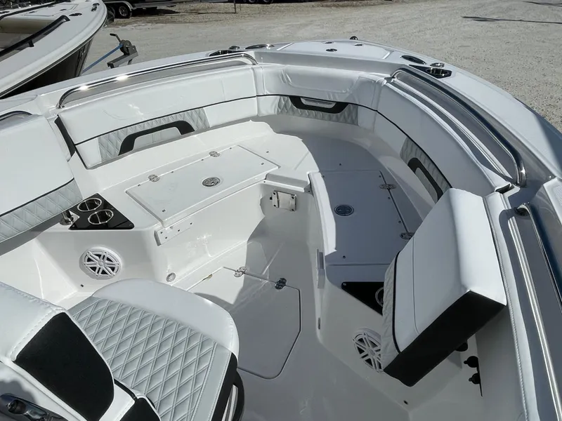 Slide: The Image of 2025 Blackfin 222CC boat interior with white seating and storage compartments. - 7