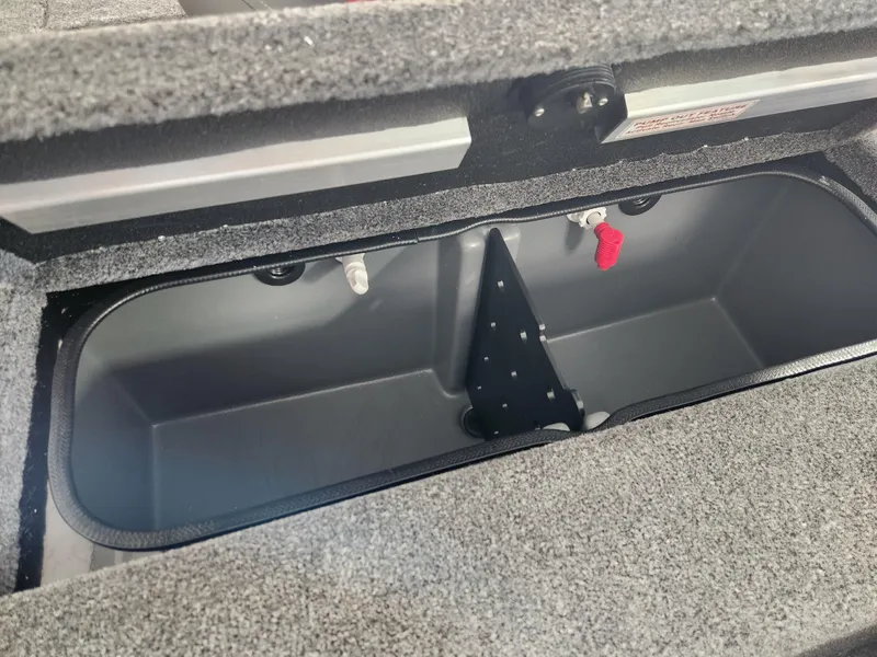 Slide: The Image of 2025 Ranger RT198P boat storage compartment with open lid, showcasing interior space. - 18
