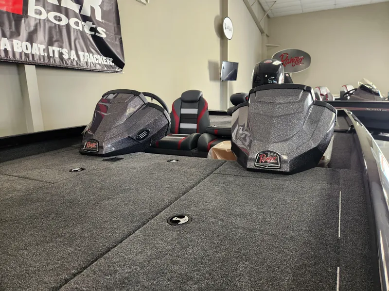 Slide: The Image of 2025 Ranger RT198P boat interior with dual consoles and seating in showroom. - 5