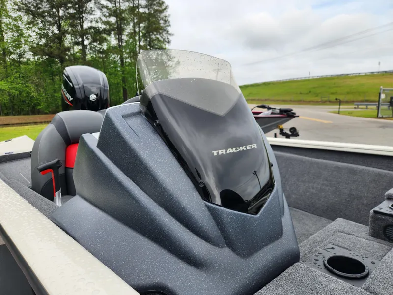 Slide: The Image of 2025 Tracker Pro Team 175 boat with sleek design and windshield, parked outdoors. - 10