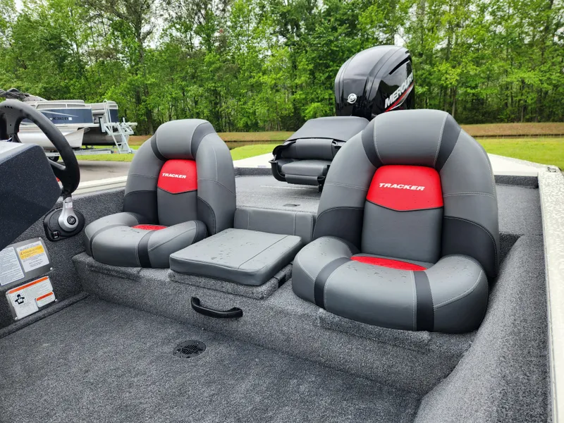 Slide: The Image of 2025 Tracker Pro Team 175 boat interior with dual seats and Mercury engine. - 11