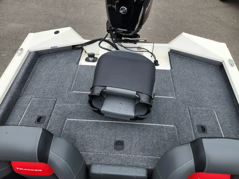 Slide: The Image of 2025 Tracker Pro Team 175 boat interior with seating and motor, featuring gray and red accents. - 13