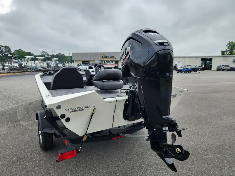 Slide: The Image of 2025 Tracker Pro Team 175 boat with powerful outboard motor in a parking lot. - 3