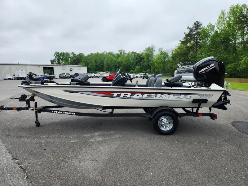 Slide: The Image of 2025 Tracker Pro Team 175 boat on trailer, parked outdoors, with Mercury outboard motor. - 5