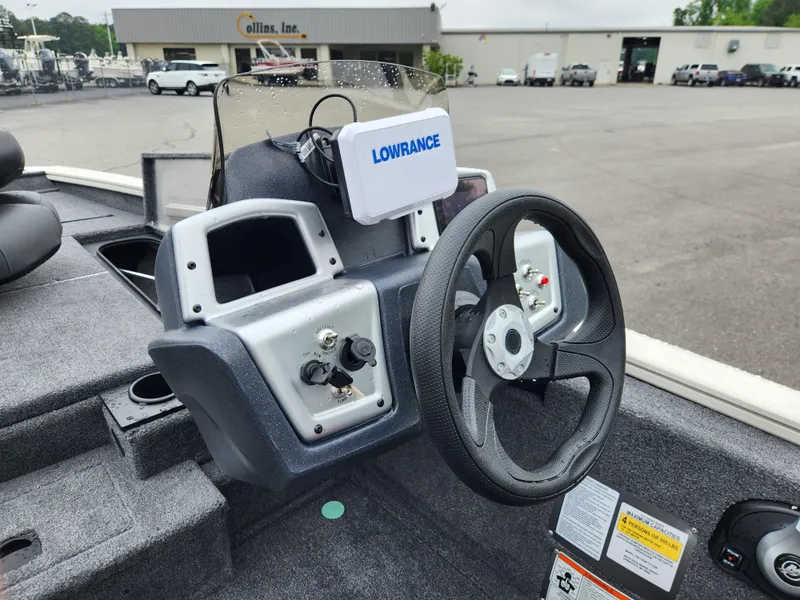 Slide: The Image of 2025 Tracker Pro Team 175 boat dashboard with steering wheel and Lowrance device. - 8