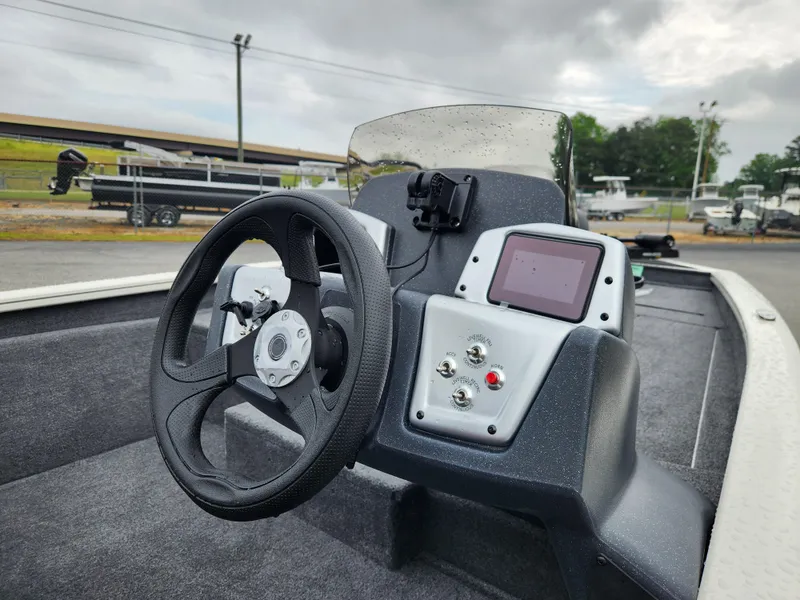 Slide: The Image of 2025 Tracker Pro Team 175 boat dashboard with steering wheel and control panel. - 9