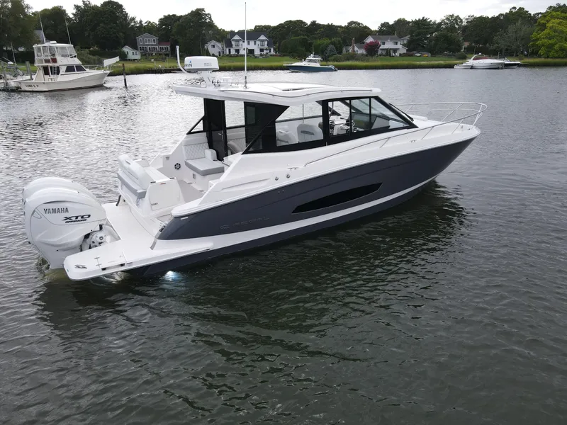 The Image of 2026 Regal 36 XO boat with Yamaha XTO engine on calm water. - 0
