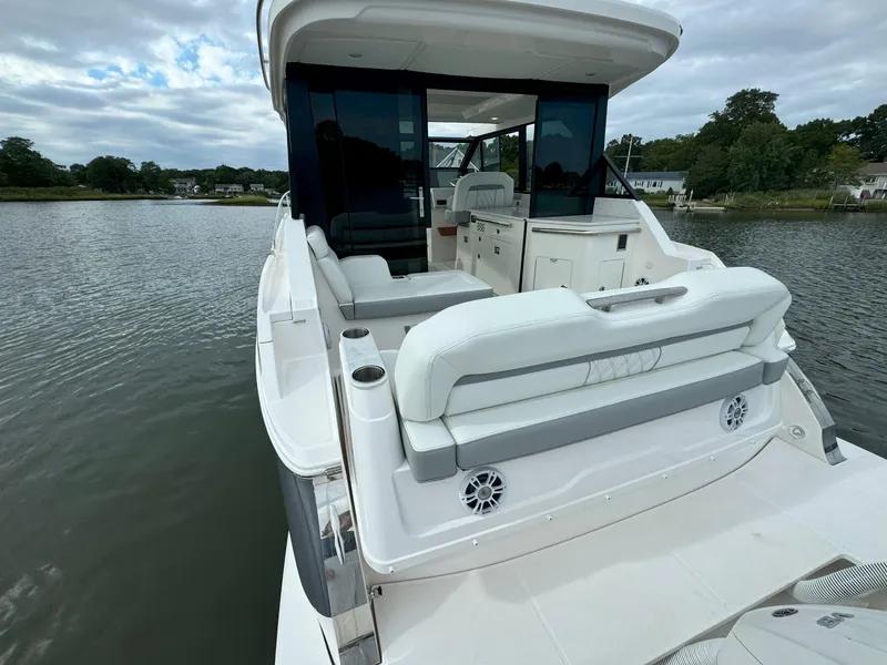 Slide: The Image of 2026 Regal 36 XO yacht with spacious seating and sleek design on calm water. - 10