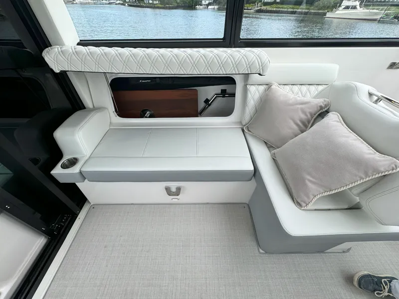 Slide: The Image of Luxurious interior seating of 2026 Regal 36 XO yacht with elegant cushions and lake view. - 18
