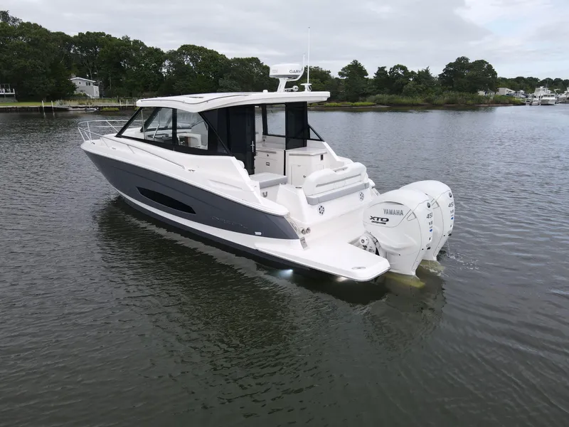 Slide: The Image of 2026 Regal 36 XO boat with Yamaha engines on calm water. - 2