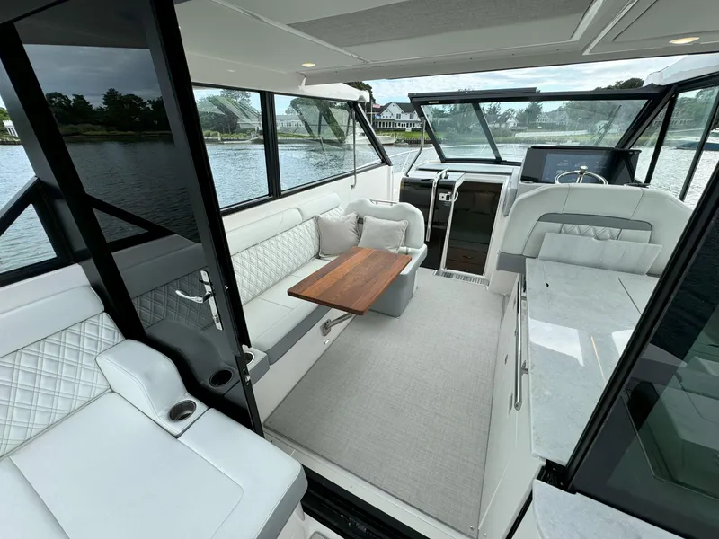 Slide: The Image of Luxurious interior of 2026 Regal 36 XO yacht with elegant seating and wooden table. - 20