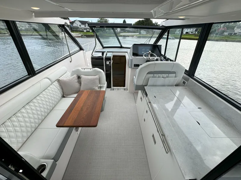 Slide: The Image of Luxurious interior of 2026 Regal 36 XO yacht with elegant seating and modern helm. - 21