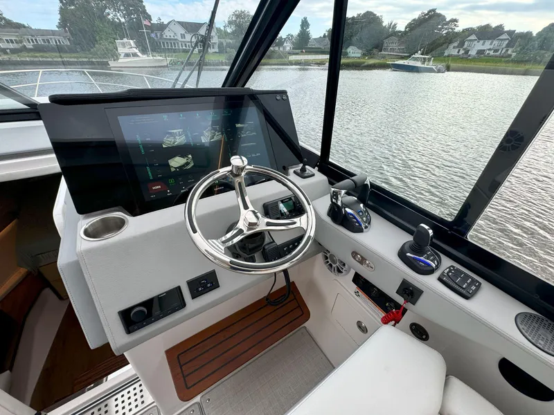 Slide: The Image of Helm of 2026 Regal 36 XO yacht with modern controls and touchscreen display. - 25