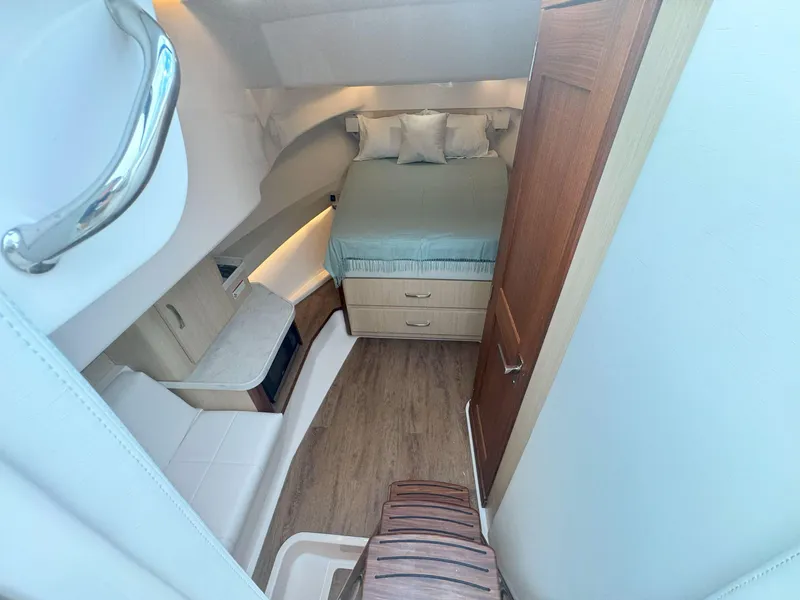 Slide: The Image of 2026 Regal 36 XO cabin interior with bed, wooden flooring, and storage drawers. - 30
