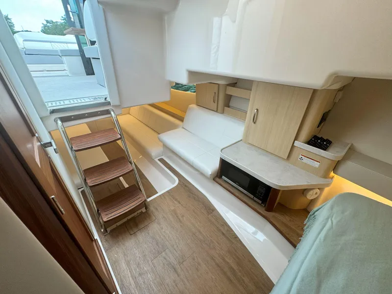 Slide: The Image of Interior of 2026 Regal 36 XO yacht with modern seating and wooden flooring. - 31