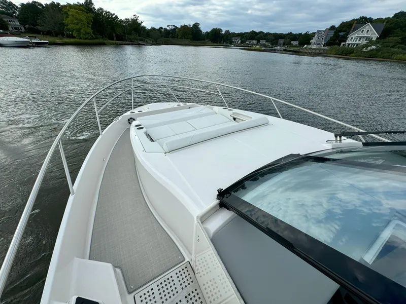 Slide: The Image of 2026 Regal 36 XO yacht on serene water, featuring spacious deck and sleek design. - 36