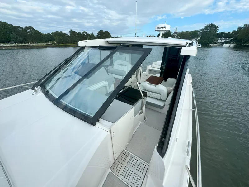 Slide: The Image of 2026 Regal 36 XO yacht on calm water, featuring sleek design and spacious seating. - 37