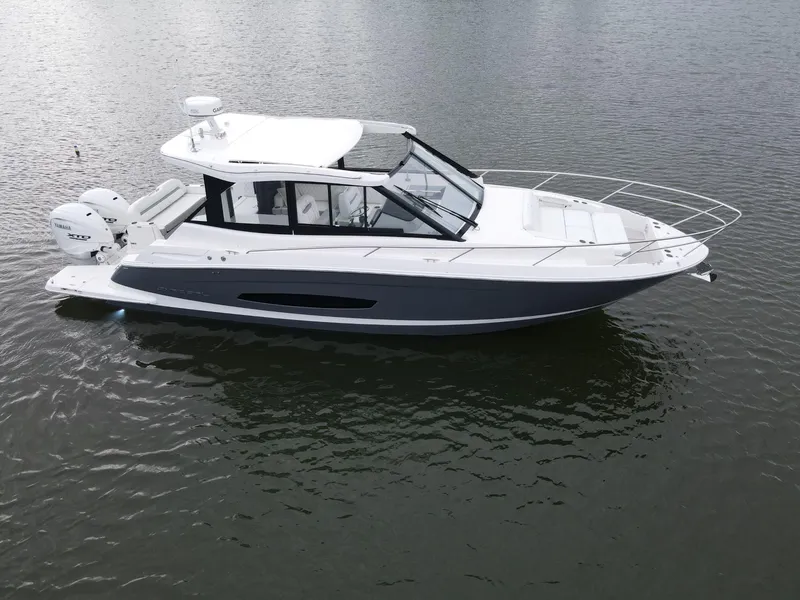 Slide: The Image of 2026 Regal 36 XO boat on calm water, showcasing sleek design and modern features. - 5