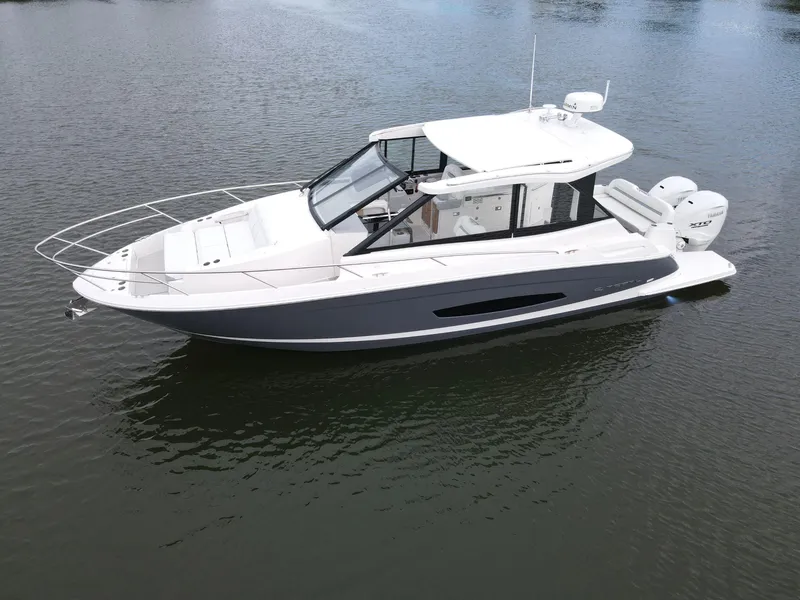 Slide: The Image of 2026 Regal 36 XO boat on calm water, side view. - 6