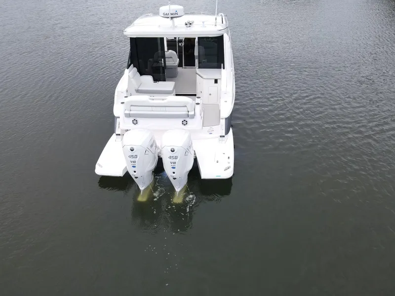 Slide: The Image of 2026 Regal 36 XO boat with twin outboard engines on calm water. - 7