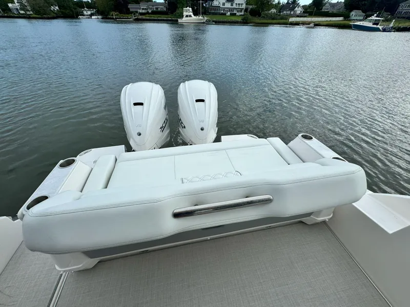 Slide: The Image of 2026 Regal 36 XO boat with dual engines on a calm lake. - 8