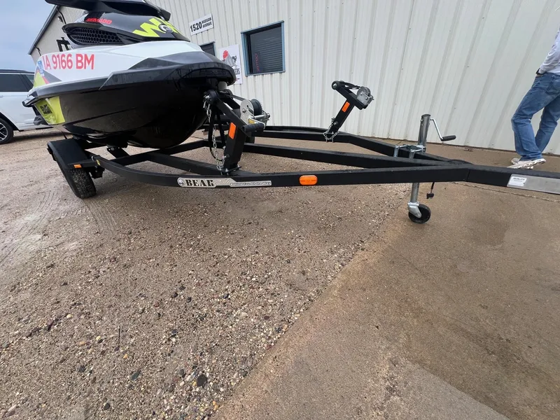 Slide: The Image of 2014 Sea-Doo Wake Pro 215 on a Bear trailer, parked outside a building. - 15