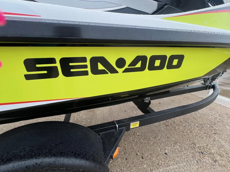Slide: The Image of 2014 Sea-Doo Wake Pro 215 on trailer, featuring bold logo and vibrant yellow design. - 2