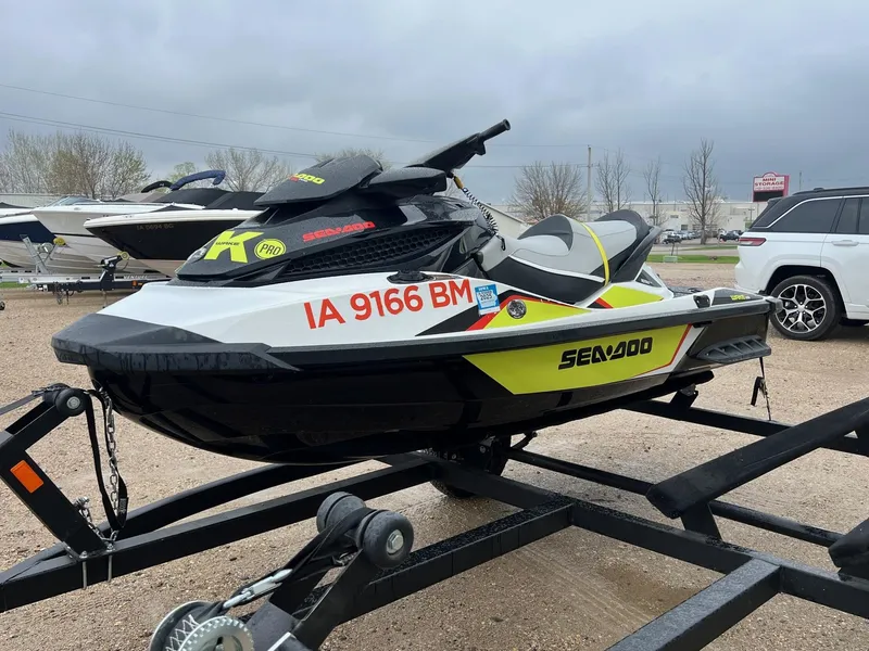 Slide: The Image of 2014 Sea-Doo Wake Pro 215 jet ski on trailer, parked outdoors. - 4