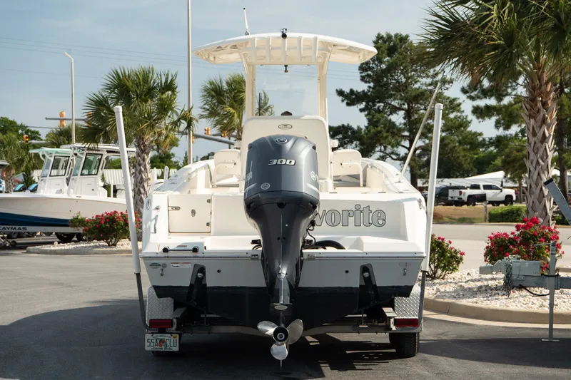 Slide: The Image of 2019 Cobia 240 Center Console boat with Yamaha 300 engine, parked outdoors. - 10