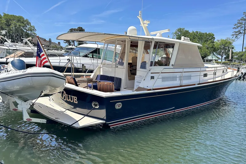 The Image of 2004 Grand Banks 49 Eastbay HX yacht docked in a marina, featuring a sleek design. - 0