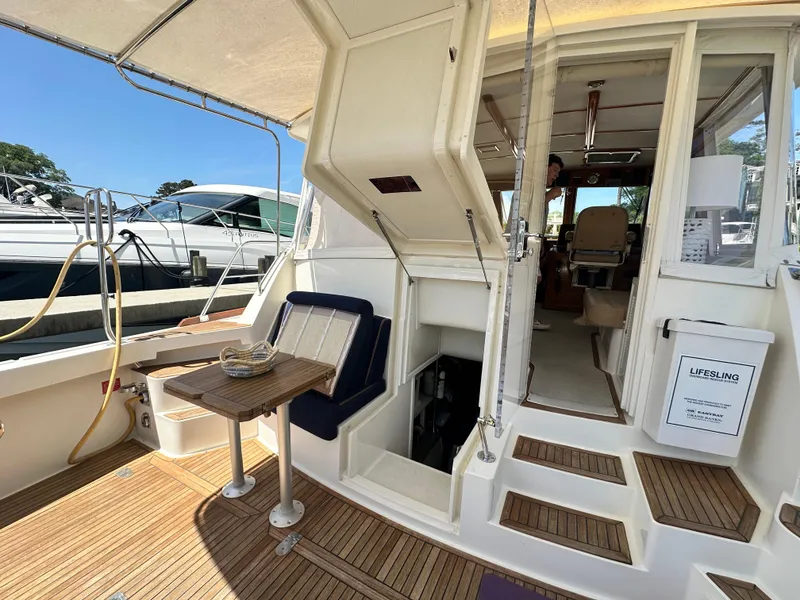 Slide: The Image of 2004 Grand Banks 49 Eastbay HX yacht interior with seating and wooden flooring. - 127